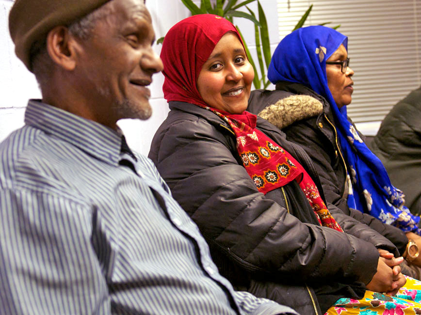 Somali man and women at a community meeting