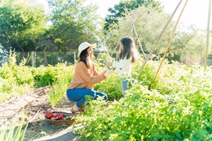 Adult and child in vegetable garden