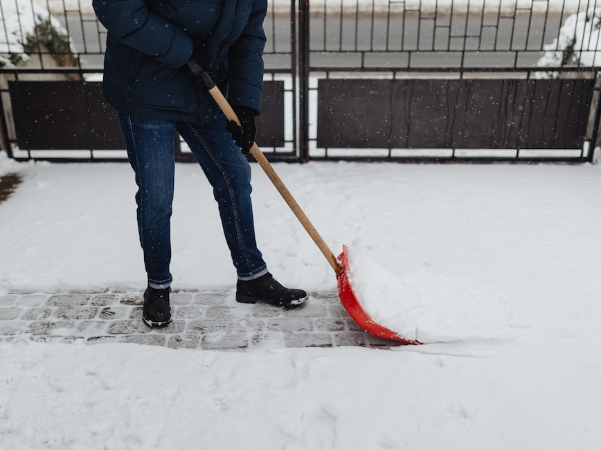 person shoveling path in snow