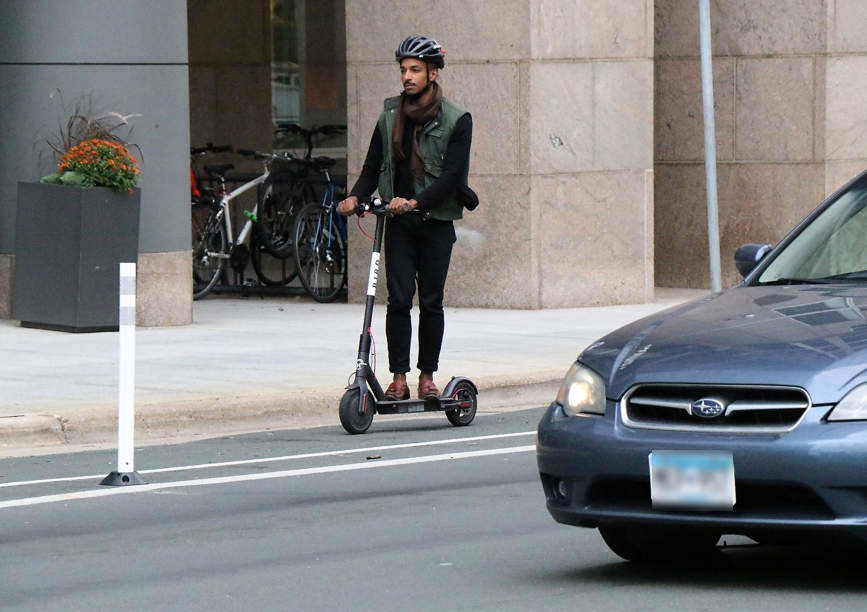 Man riding scooter downtown Minneapolis