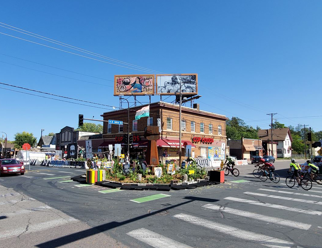 View of the intersection with George Floyd Memorial flowers and art