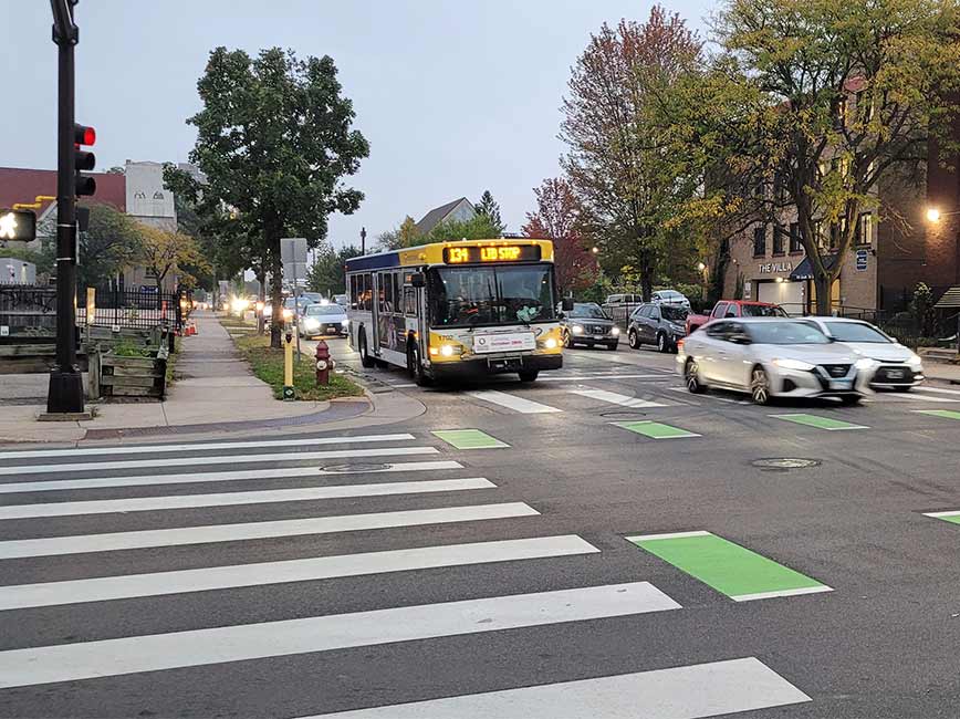 Intersection of 7th St S with a crosswalk, bike lane, and bus