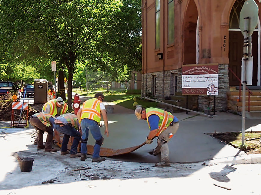 Photo of City staff upgrading pedestrian ramps