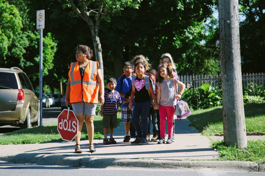 Children crossing street with safety patrol present