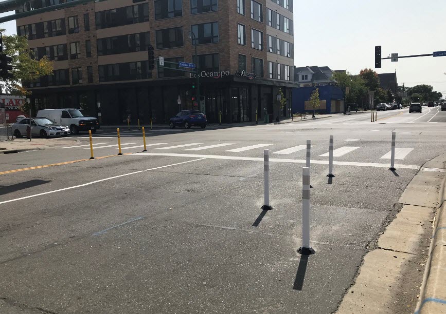 Delineator bumpouts - bumpouts narrow the roadway. This creates safer and shorter pedestrian crossings.