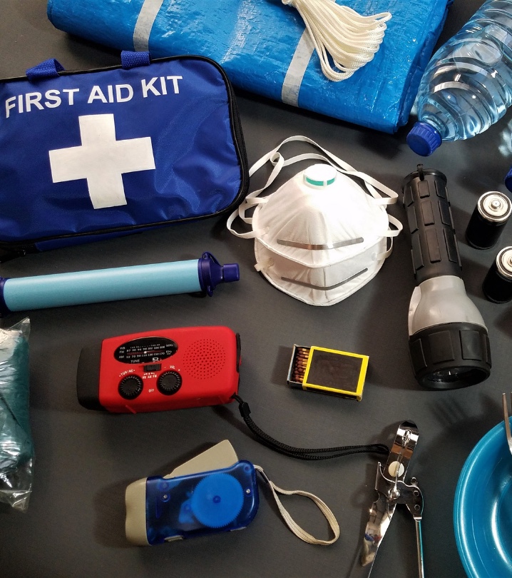 Water, masks, first aid kit, food, flashlight and other emergency kit items.