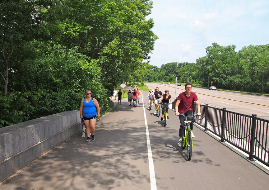 People walking and biking on a protected path.