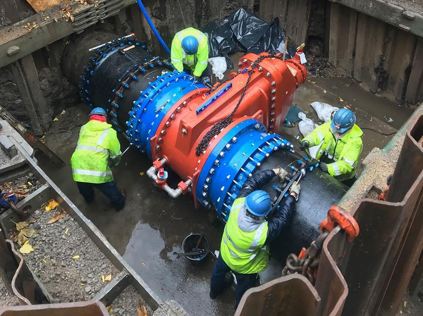 PW employees working on a large pipe