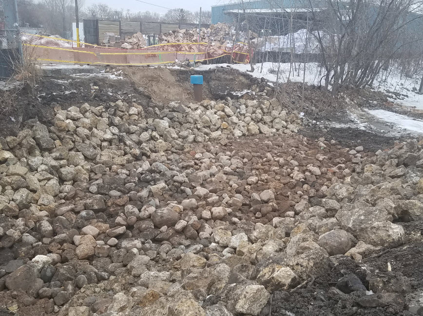 Rocks in emptied Bassett Creek at sewer construction site
