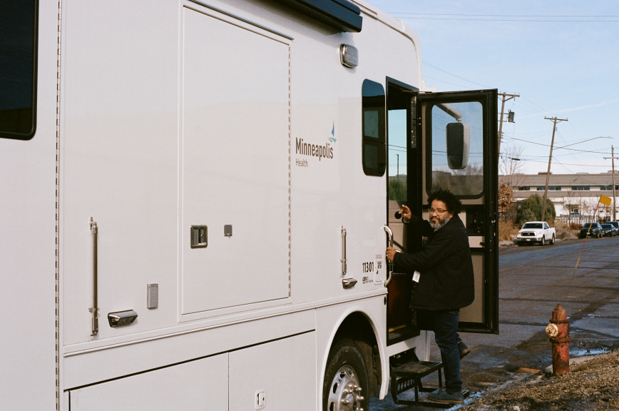 Person stepping into Mobile Medical Unit vehicle 