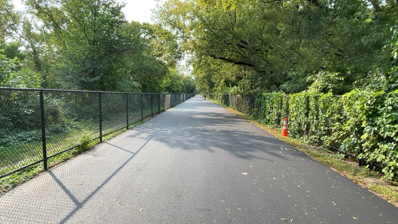 Bike and pedestrian trail from ground level, with fresh pavement