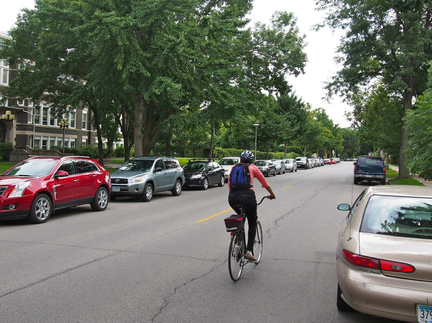 Parked cars and bicyclist.