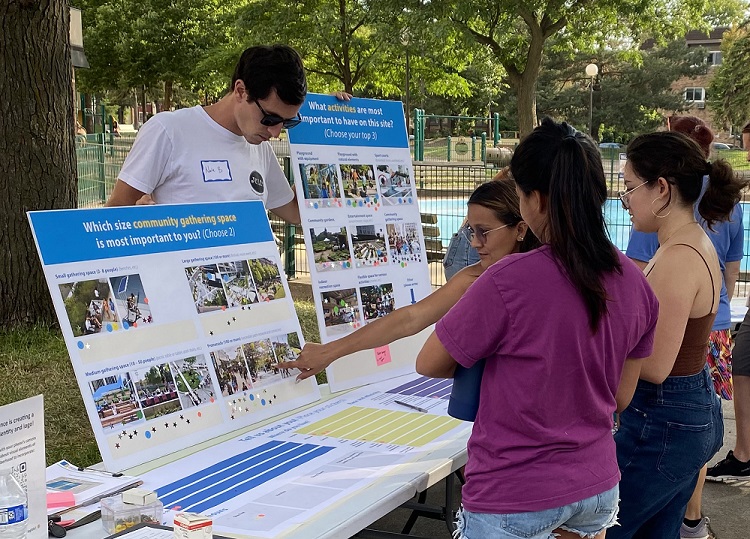 People gathering around a display outside