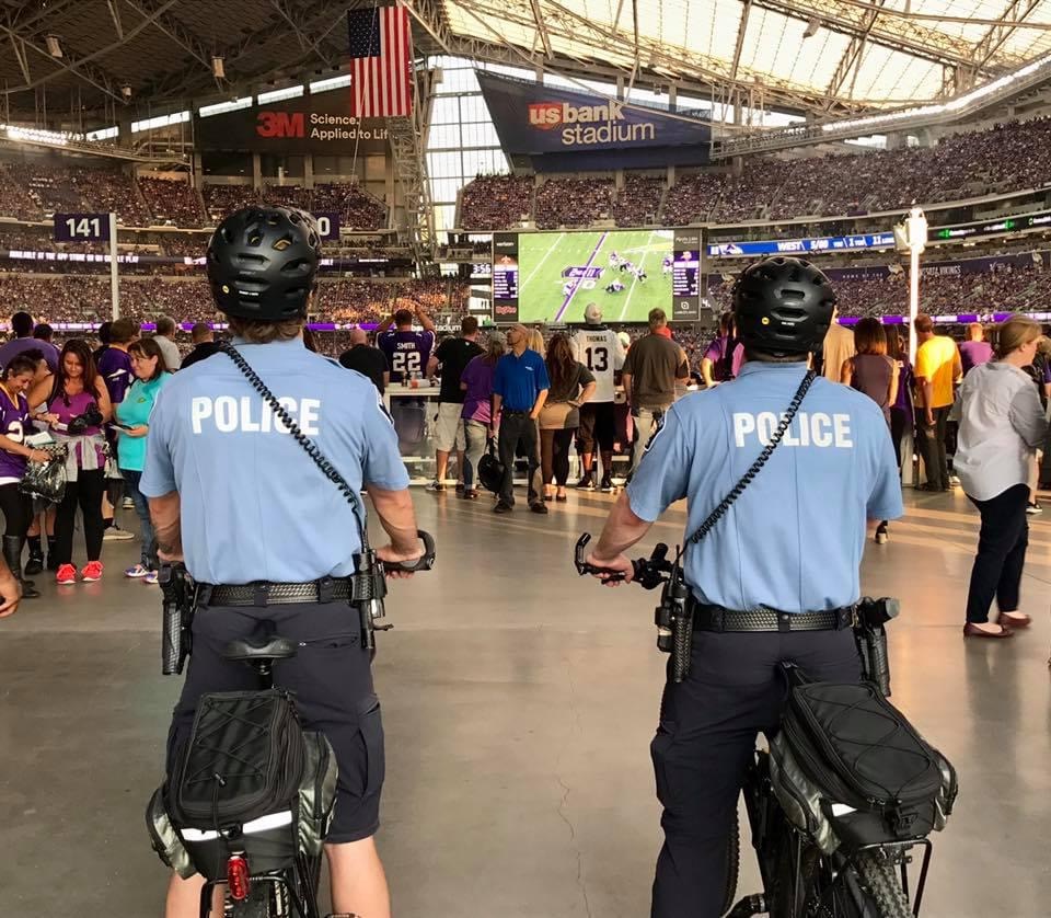 Two officers on bikes at an event.