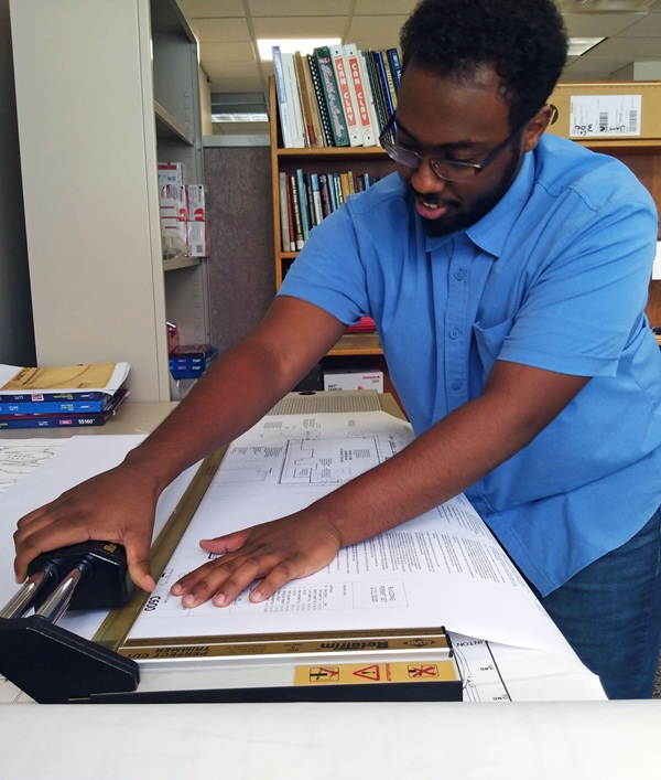 Person working in office with blueprint Person working in office with blueprint