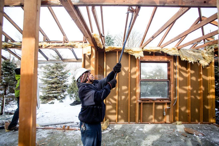 person deconstructing a residential building