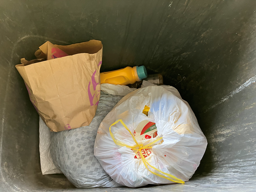 bagged garbage inside a garbage cart