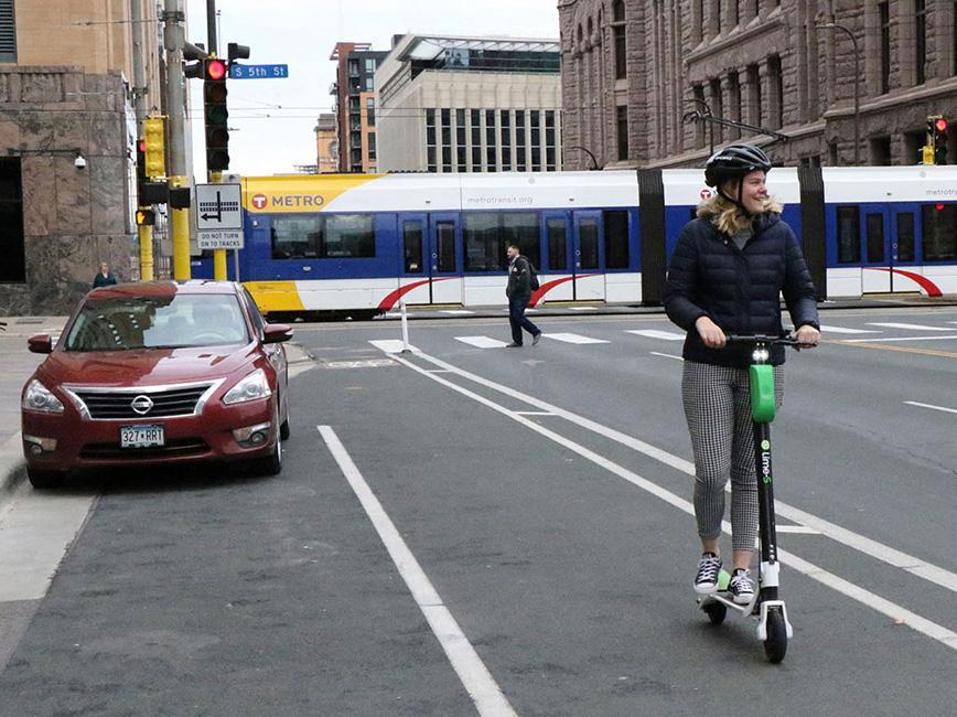 Woman riding on scooter downtown Minneapolis