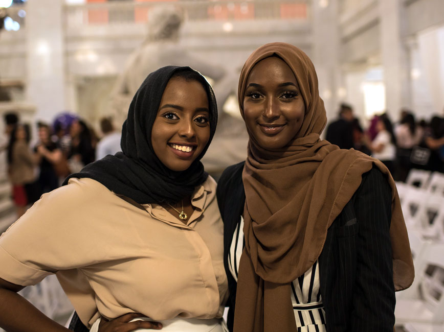 Two Scholars posing and smiling.