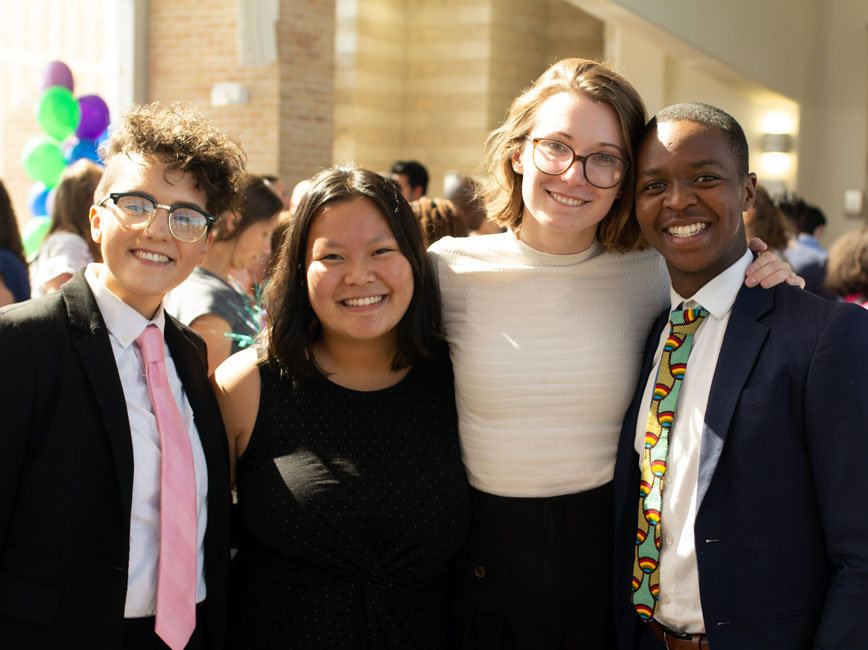 Group of four Scholars standing and smiling