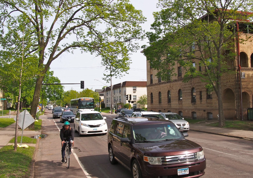 A person on bicycle riding in bike lane