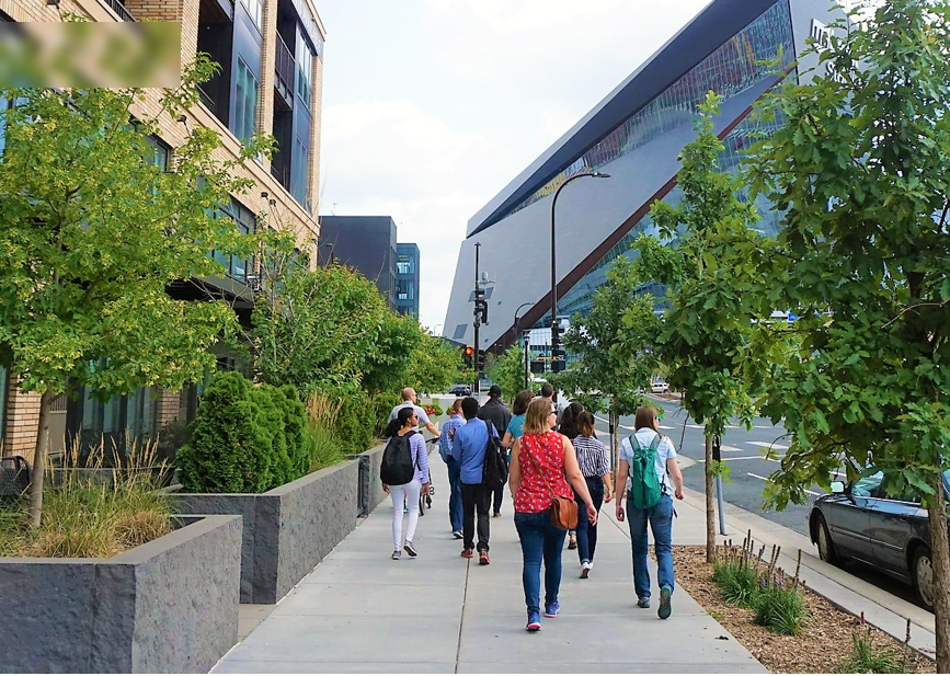 A crowd of people walk toward the US Bank Stadium in downtown Minneapolis.