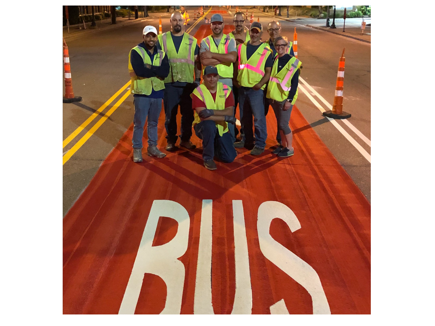Construction workers in front of bus lane
