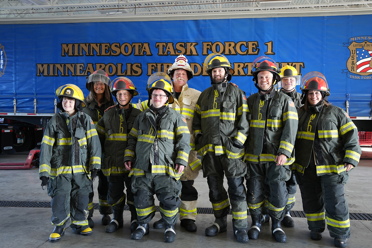 A group of community members dressed in Minneapolis firefighter gear.