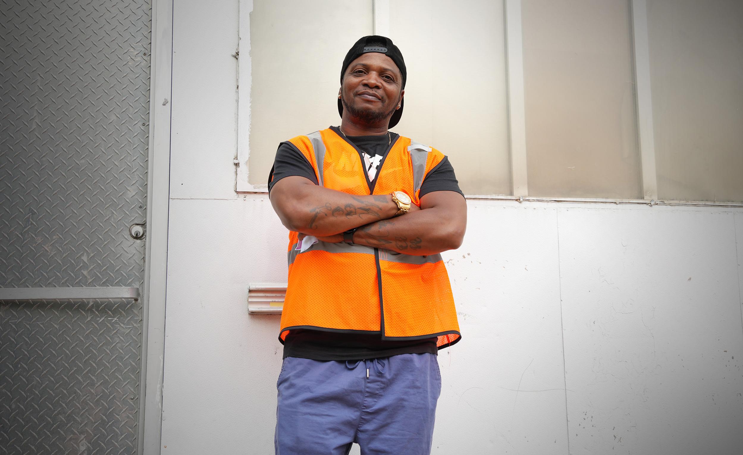 A violence interrupters team member poses near a corner store in North Minneapolis.