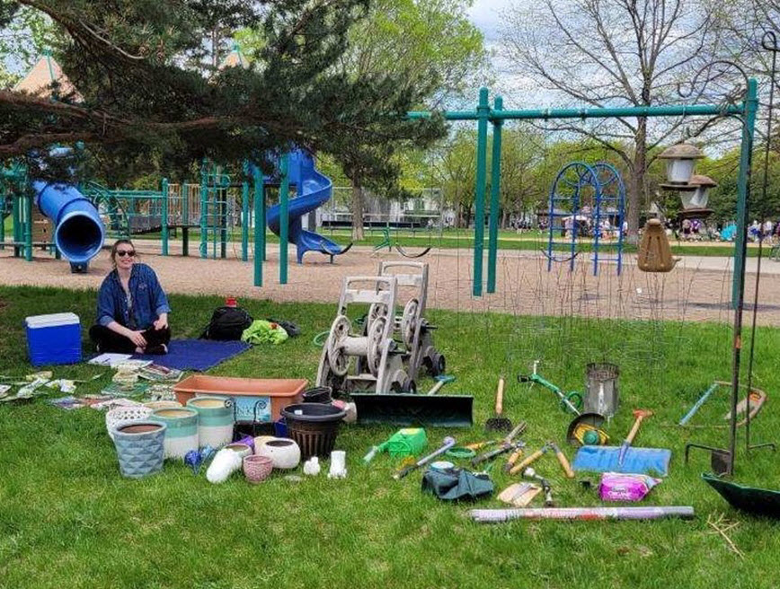 Garden tools to give away arranged on the grass in a park