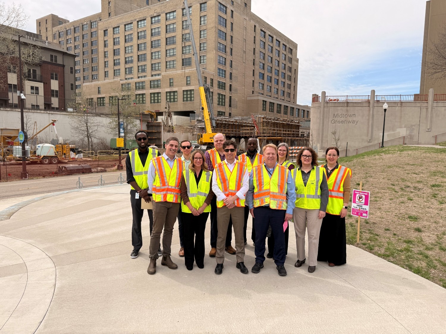Mayor Jacob Frey and Public Works Director Tim Sexton are joined by Public Works leadership in front of the 10th Avenue S. bridge construction site.