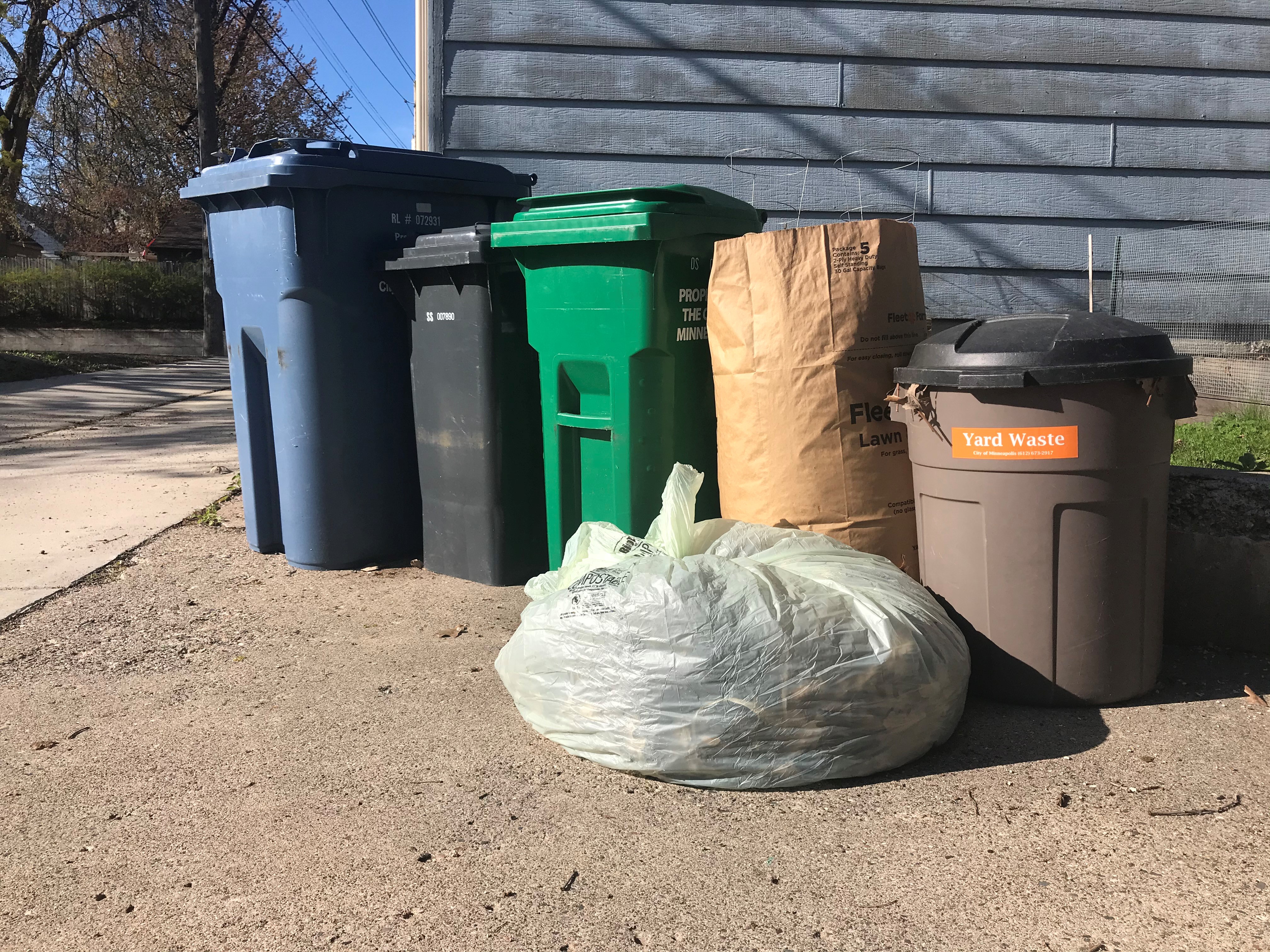 Yard waste in compostable bags and a reusable container