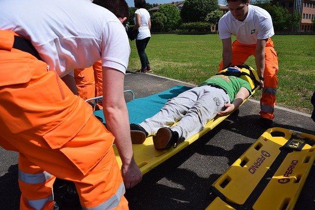 Fire Pathways Program members helping a person on a stretcher