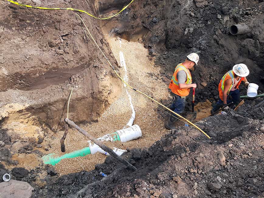 people working on the sewer.