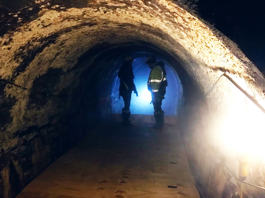 Construction worker looking into Central City tunnel