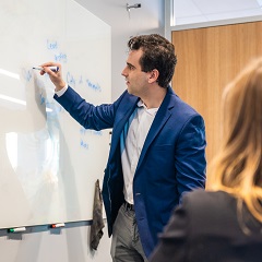 person writing on whiteboard