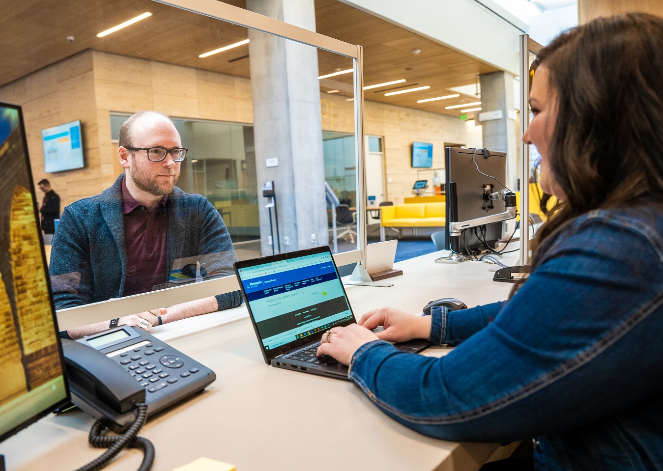 person at computer helping someone