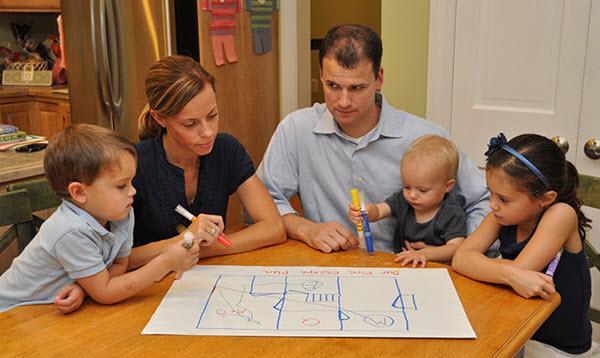 Family creating fire emergency exit drawing