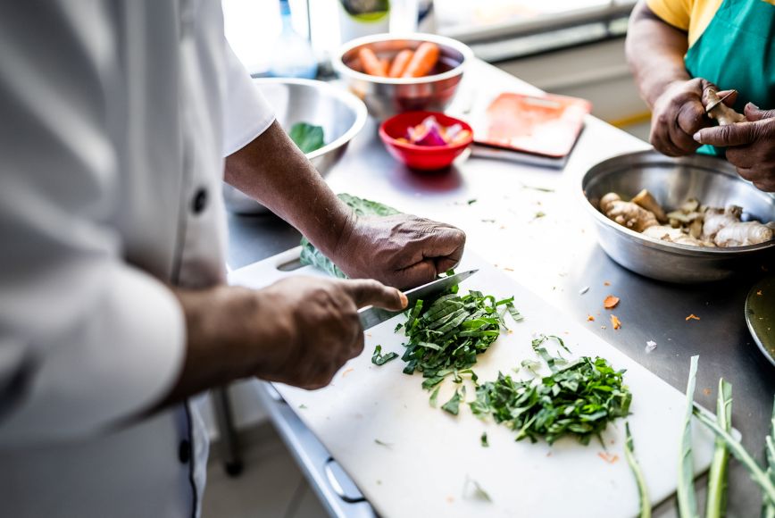 Hands chopping vegetables