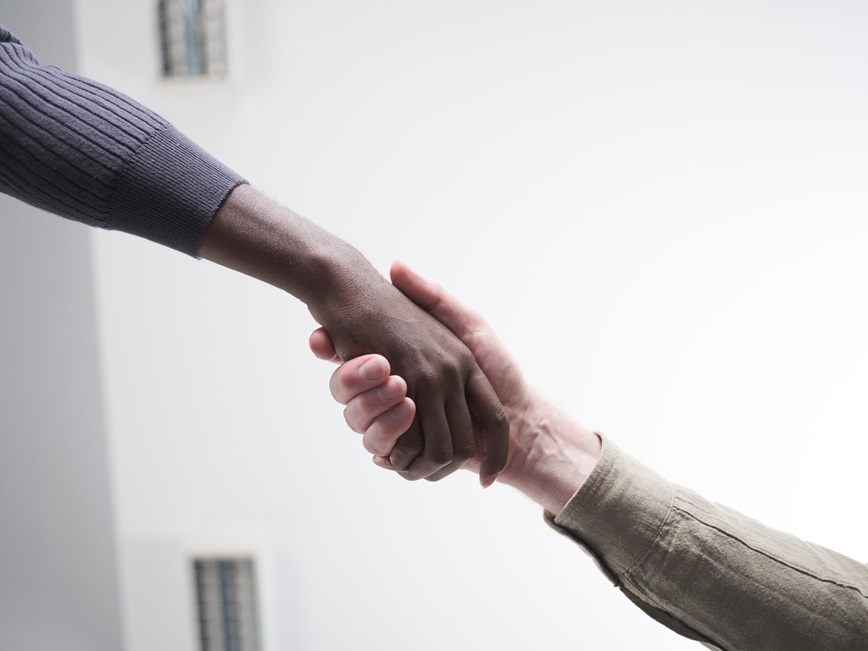 Two hands holding supportively. 
