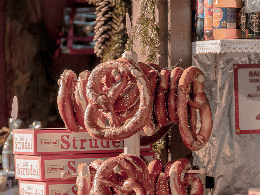 Indoor food cart selling pretzels and other packaged foods.