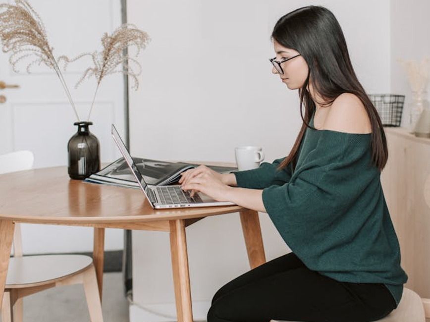 Person working at laptop at home Person working at laptop at home
