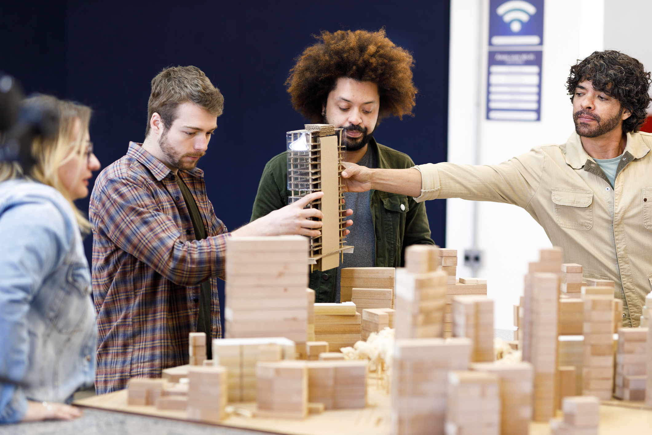 People looking at building model