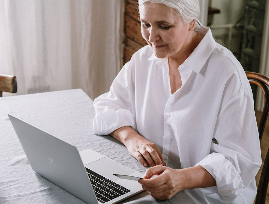 Person on laptop using credit card