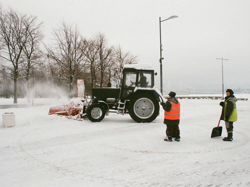 Snow and plow workers plowing and shoveling