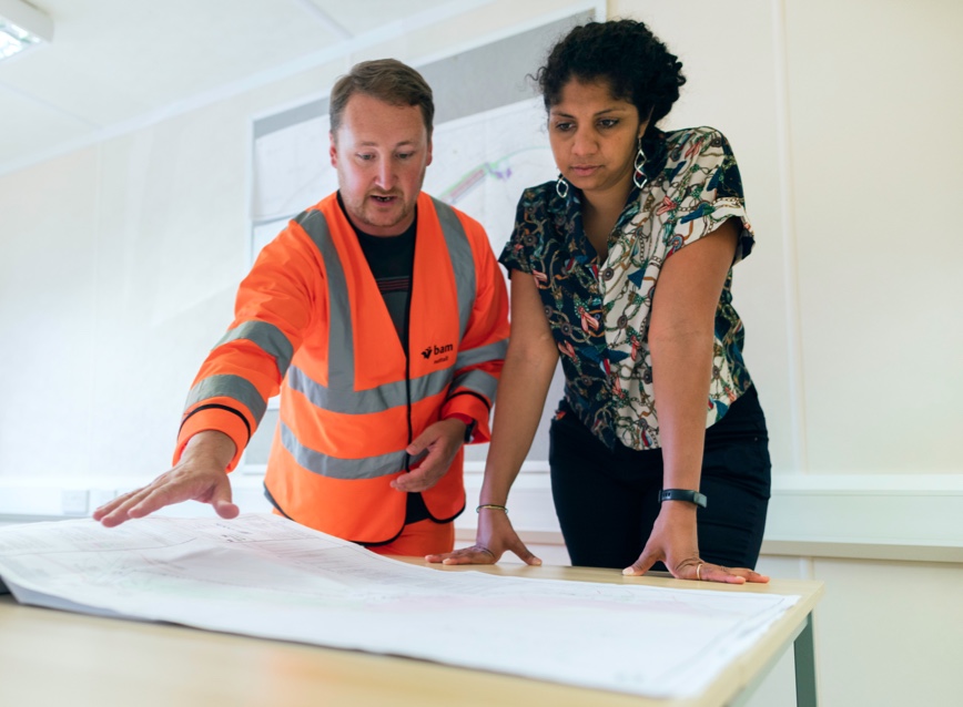 Architect and engineer looking at plans