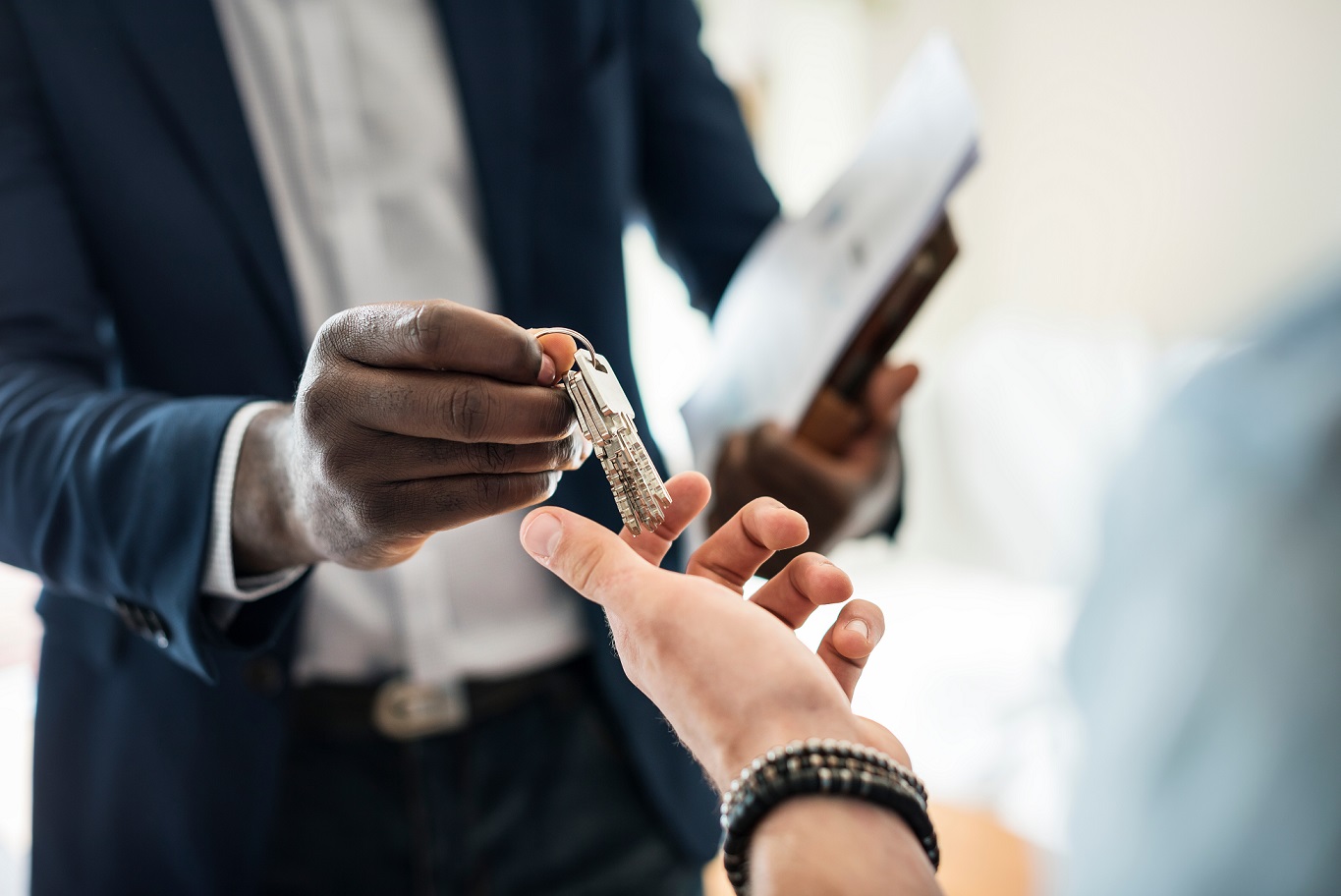 person handing keys to another person