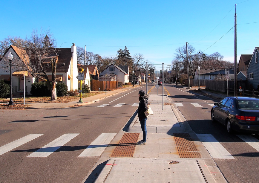 Person waiting between crosswalks in Mpls